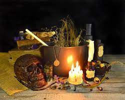 Skull, herbs and candles on a healer's working altar